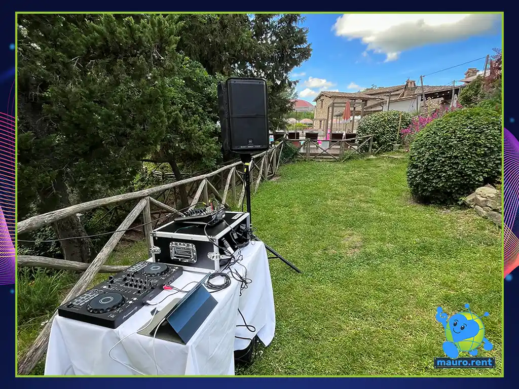 Clean panoramic perspective of the outdoor morning brunch audio station with Borgo Castello Panicaglia in background