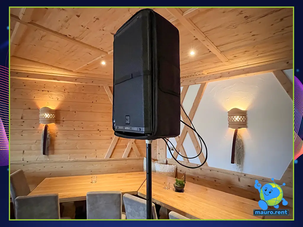 Close-up of an RCF Art 912-A active loudspeaker installed inside the wooden interior of the Col Pradat lodge for wedding dinner speeches and background music.