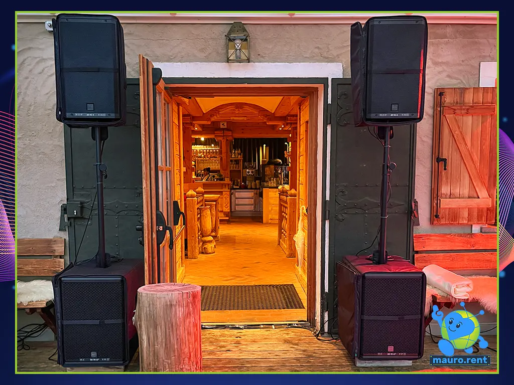 Symmetric audio setup with two RCF Sub 705-AS MK3 subwoofers and two RCF Art 912-A speakers placed on both sides of the Col Pradat lodge entrance door.