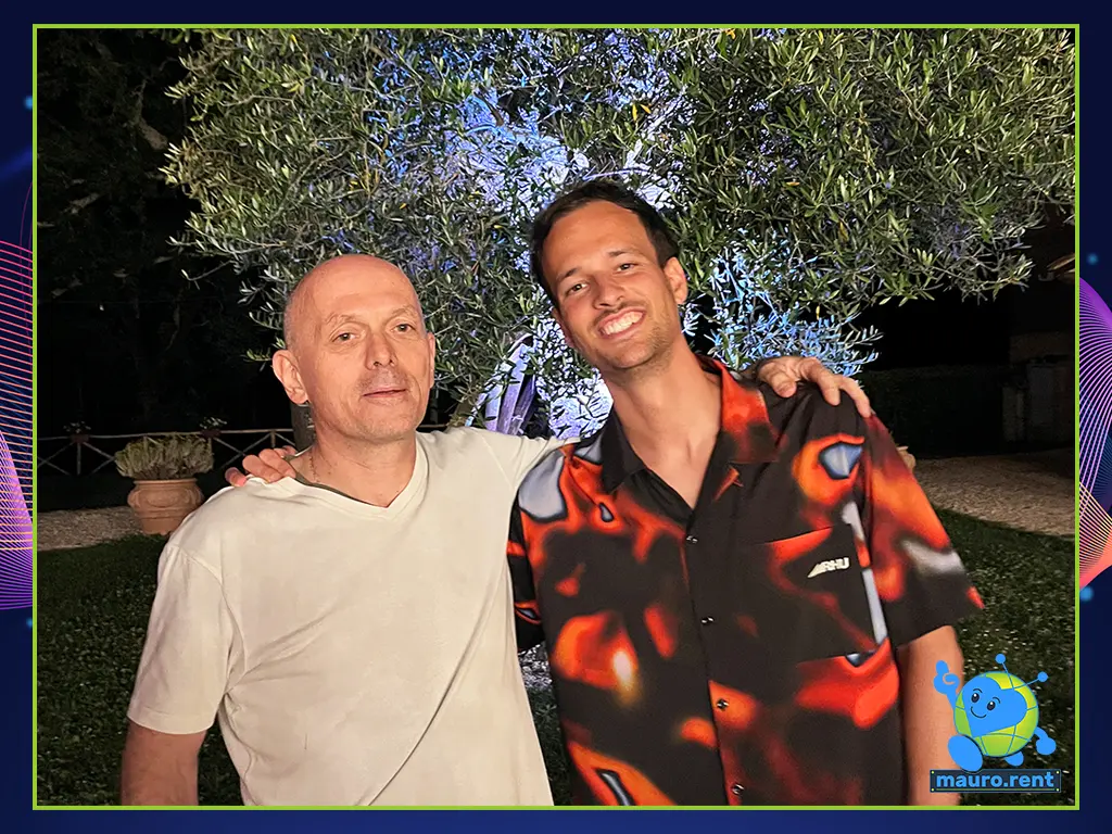 Mauro and DJ Bas posing together at the DJ booth after closing the wedding dance floor at Agriturismo Terre di San Galgano.