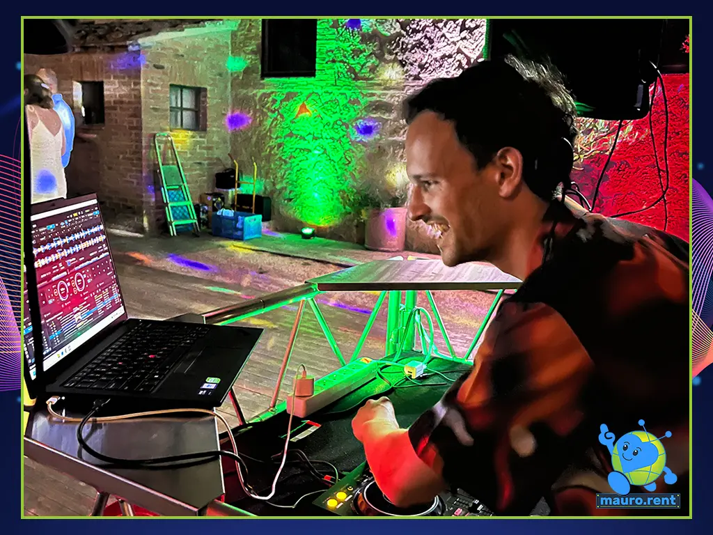 Close-up of a smiling DJ Bas performing live during the wedding dance floor set at Agriturismo Terre di San Galgano.