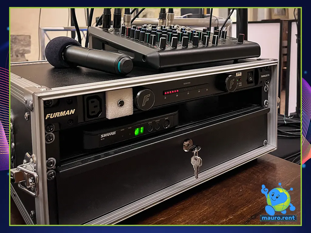 Close-up of the professional technical rack featuring the Furman PL-Plus CE power conditioner, Shure BLX wireless receiver, and RCF F 10XR mixing console.