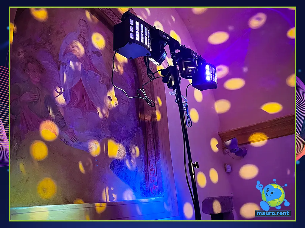 Close-up of the BeamZ lighting matrix on a Gravity stand, highlighting the Magic1 effects and MHL36 moving heads against the historic altar fresco at Abbazia San Faustino.