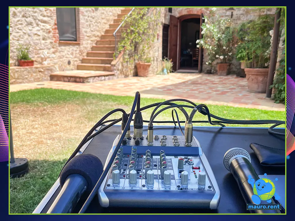 Behringer mixer console setup with Sennheiser wired microphone and an American Shure wireless microphone