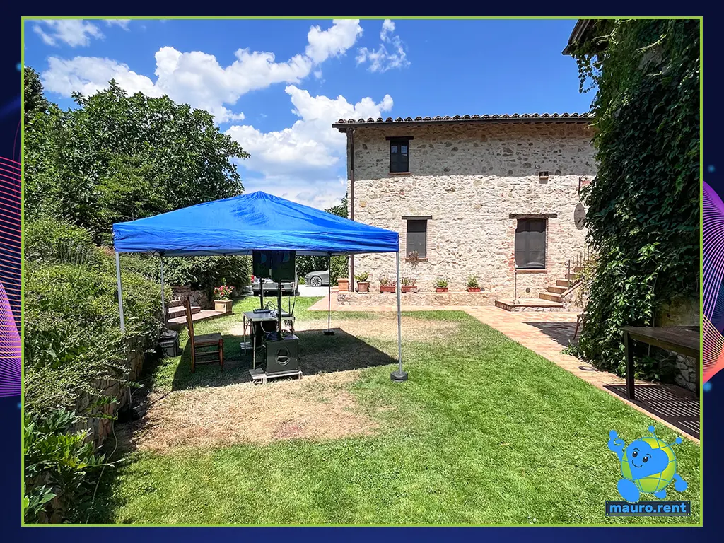 View from Villa Capanne swimming pool area looking towards the gazebo with Behringer audio system and farmhouse entrance